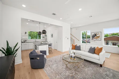 a living room with furniture potted plant and a window