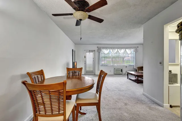 a dining room with furniture a chandelier and a rug