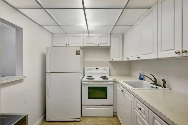 a white refrigerator freezer sitting inside of a kitchen