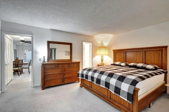 a bedroom with a bed and dresser