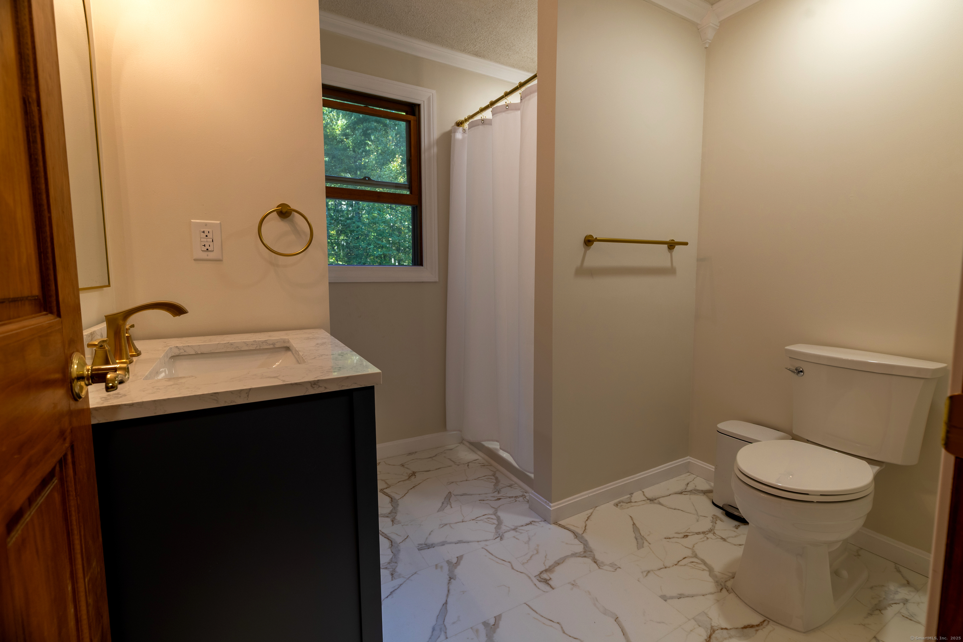 48 Quailcrest Road East Lyme, CT 06333 - Photo 21 of 31 a bathroom with a sink toilet and window