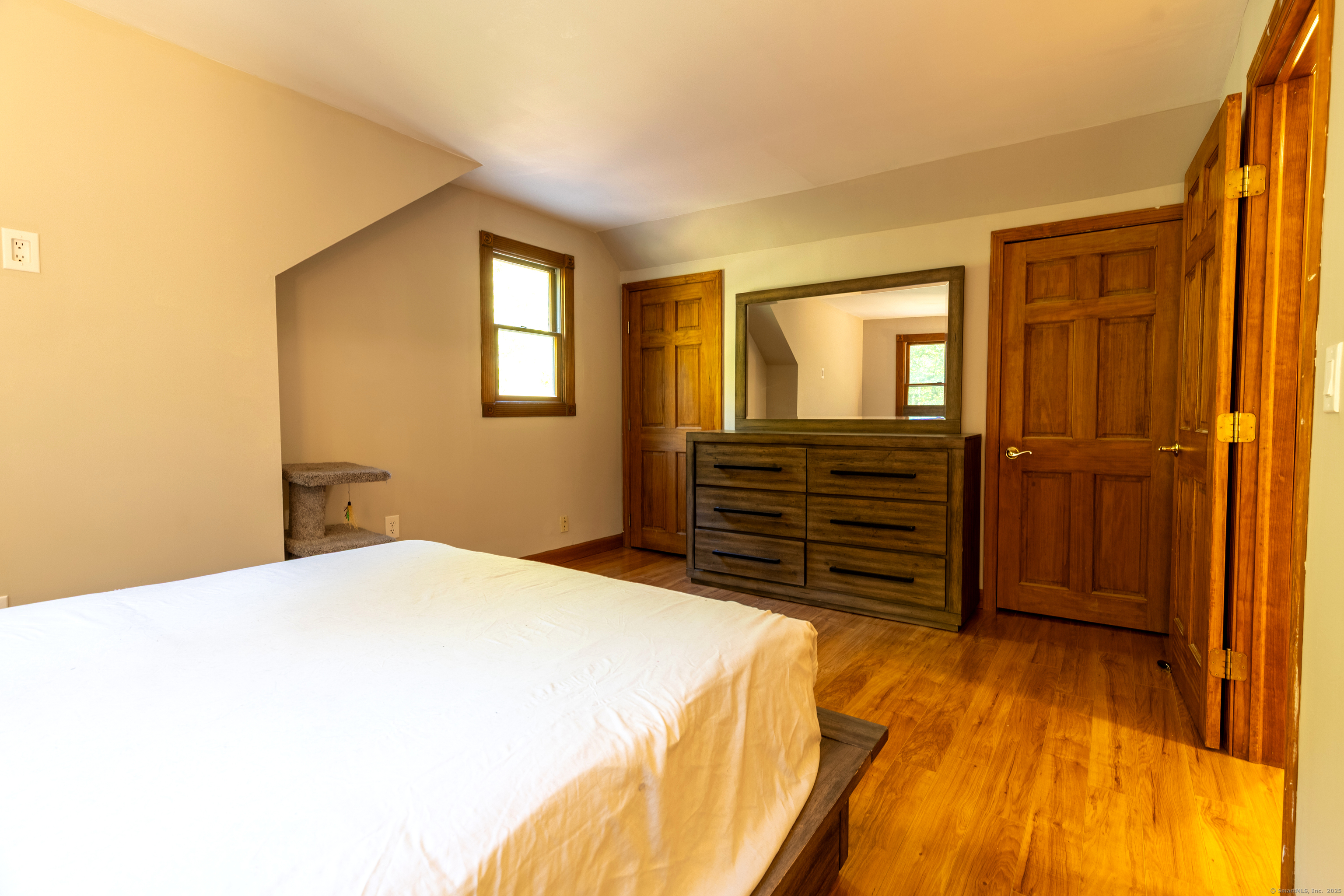 48 Quailcrest Road East Lyme, CT 06333 - Photo 24 of 31 a bedroom with a bed and wooden floor