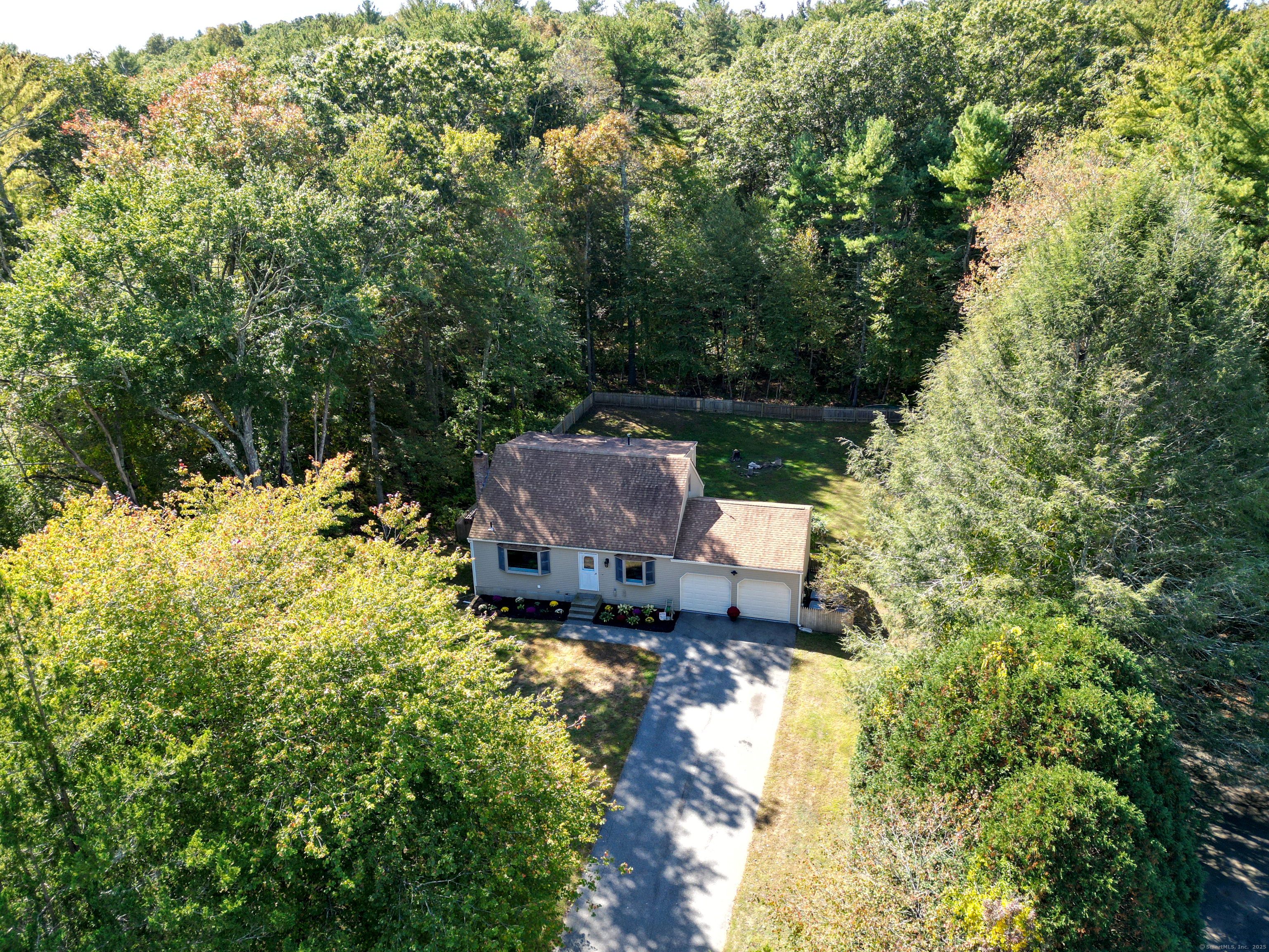 48 Quailcrest Road East Lyme, CT 06333 - Photo 30 of 31 a backyard of a house with table and chairs and wooden fence