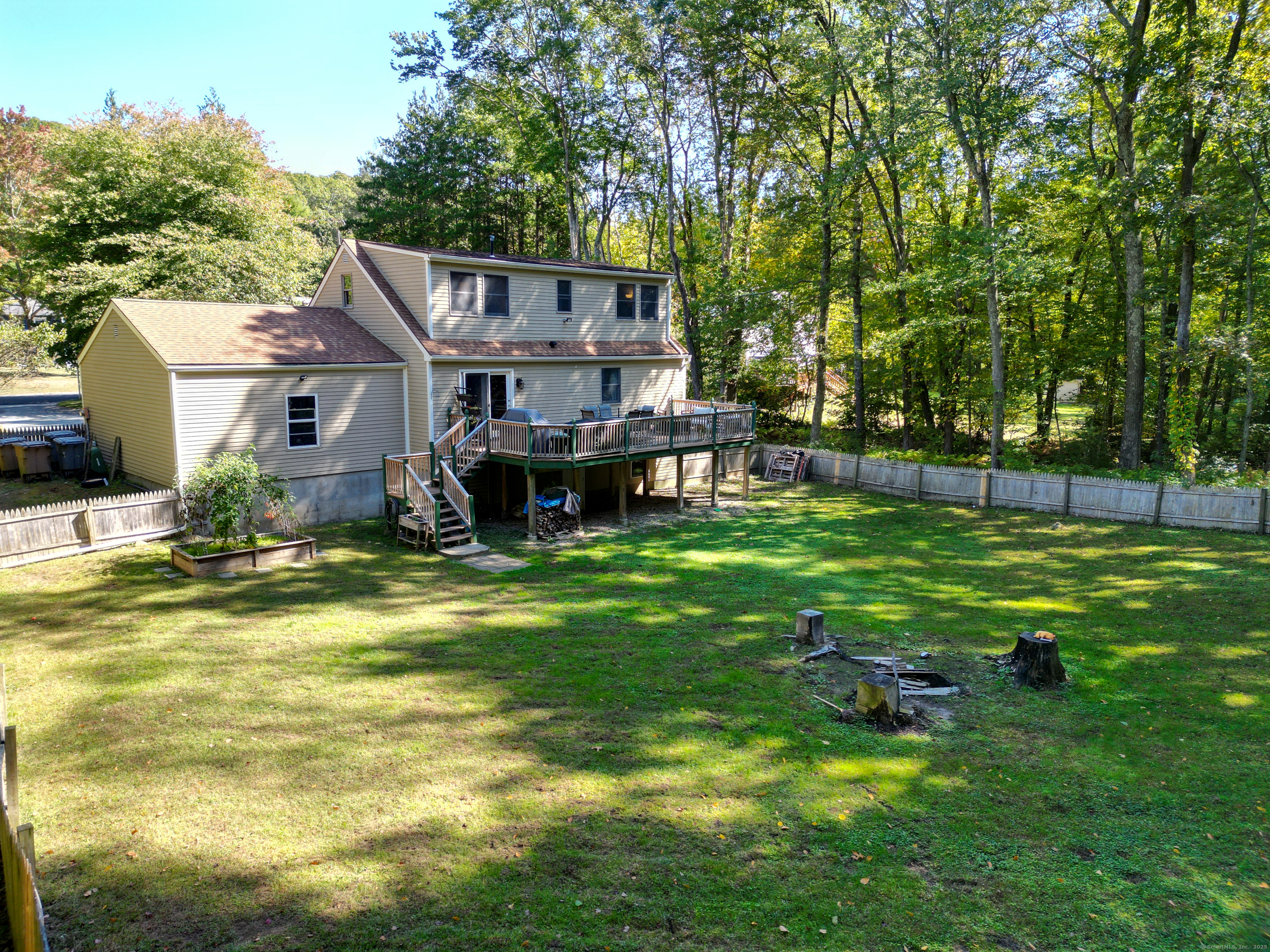 48 Quailcrest Road East Lyme, CT 06333 - Photo 31 of 31 a view of a house with a big yard potted plants and large tree