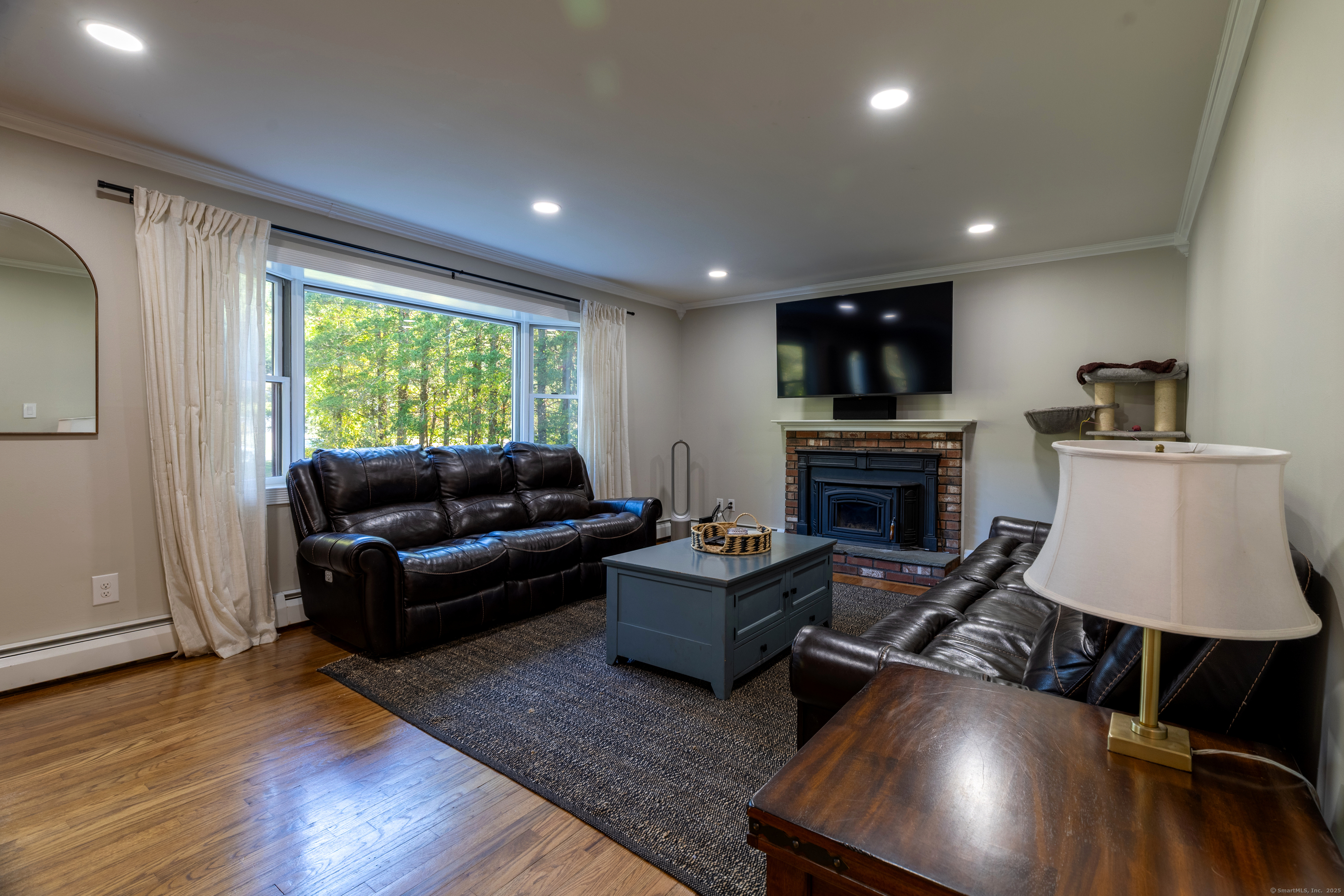 48 Quailcrest Road East Lyme, CT 06333 - Photo 10 of 31 a living room with furniture and a fireplace