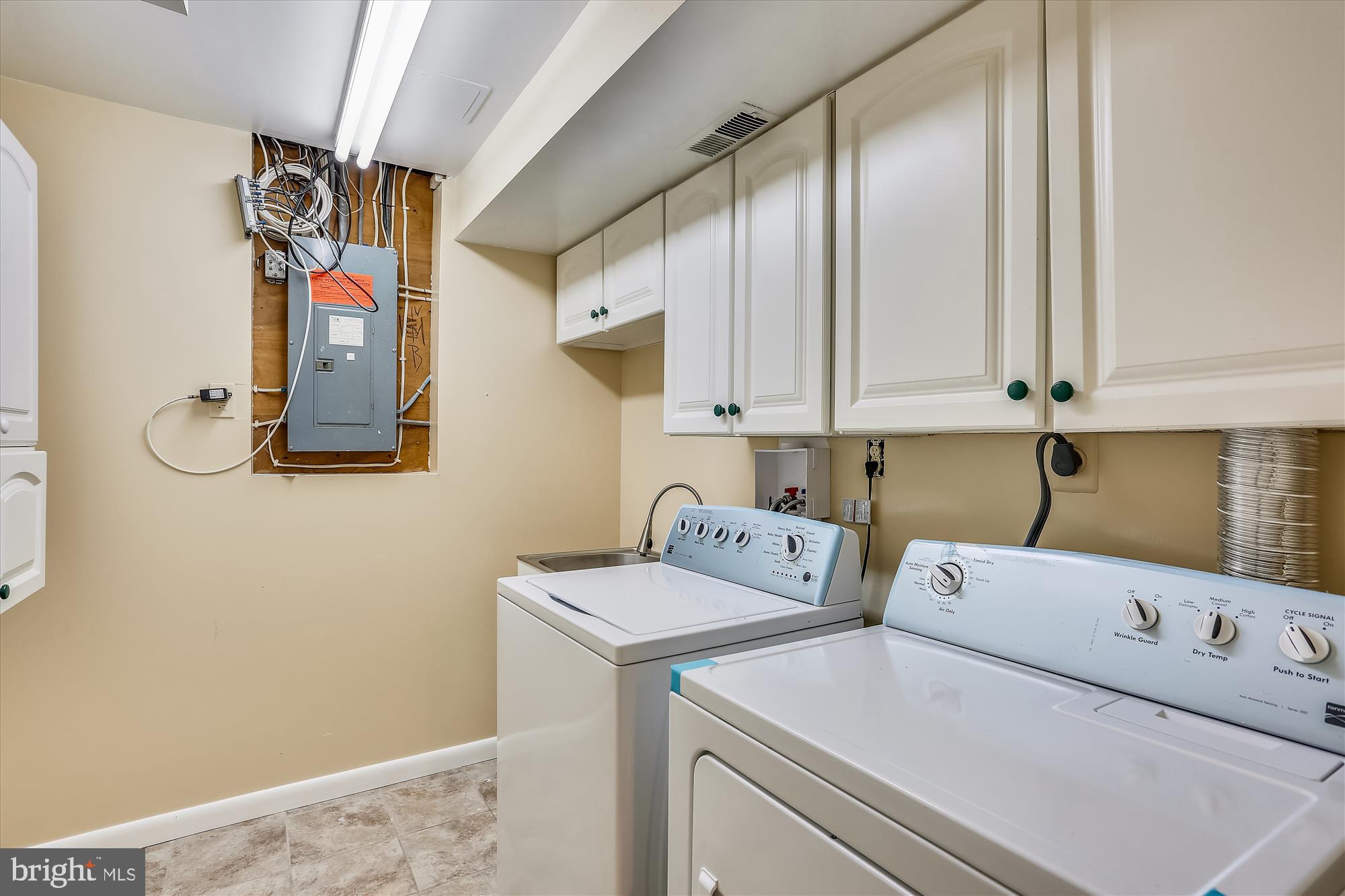 8908 Spring Berry Court Gaithersburg, MD 20886 - Photo 43 of 59 Laundry Room with washer, dryer, sink and cabinets