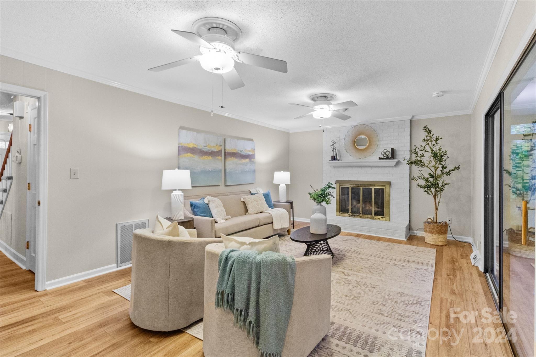 348 Beverly Circle Charlotte, NC 28270 - Photo 11 of 45 a living room with furniture a fireplace and a chandelier