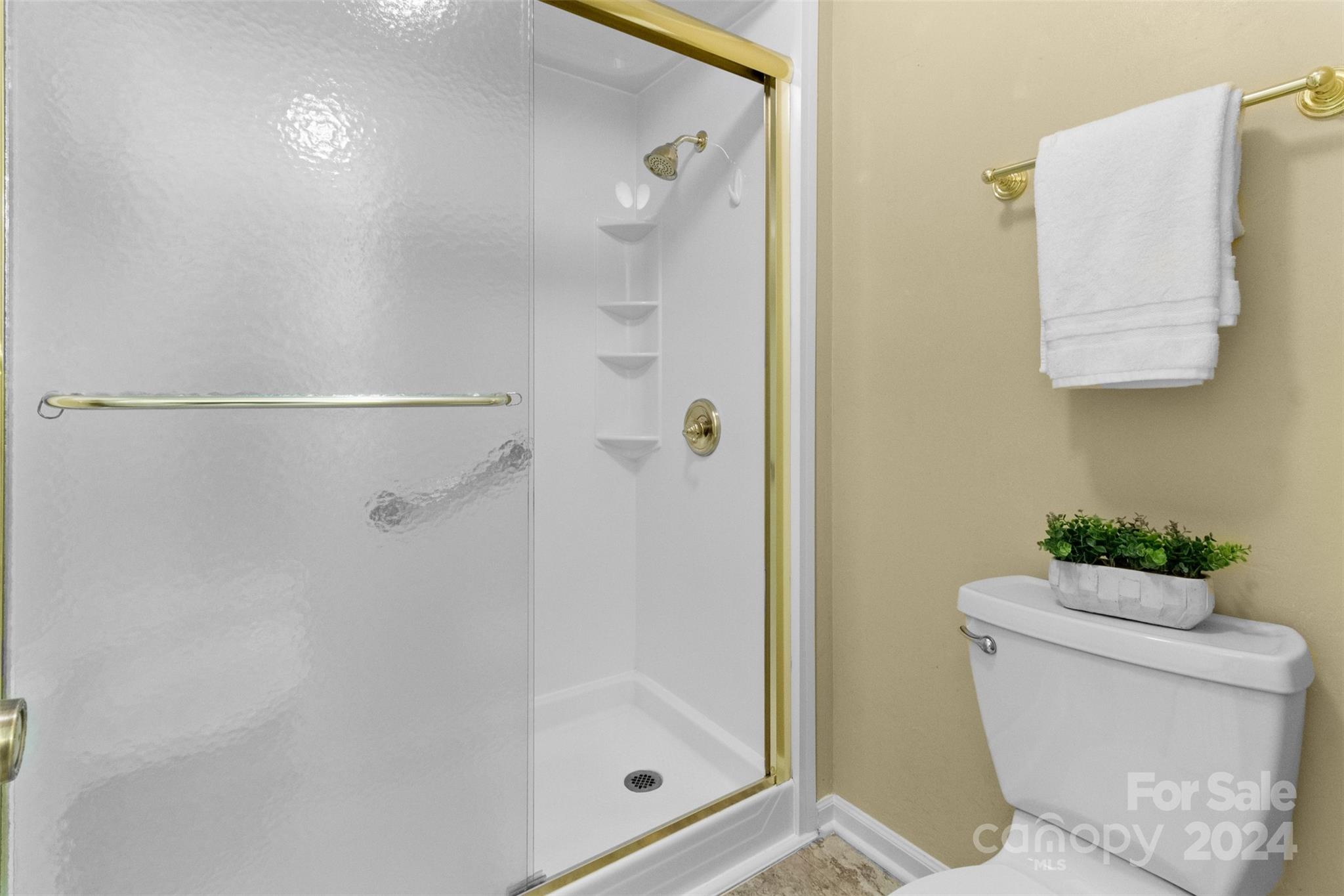 348 Beverly Circle Charlotte, NC 28270 - Photo 21 of 45 a bathroom with a shower a toilet and a sink