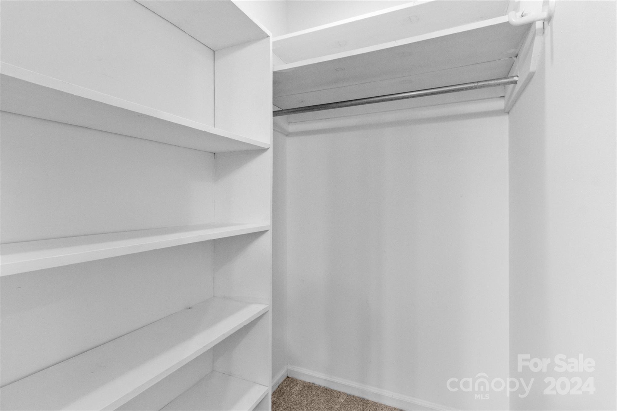 348 Beverly Circle Charlotte, NC 28270 - Photo 23 of 45 a view of walk in closet with empty racks