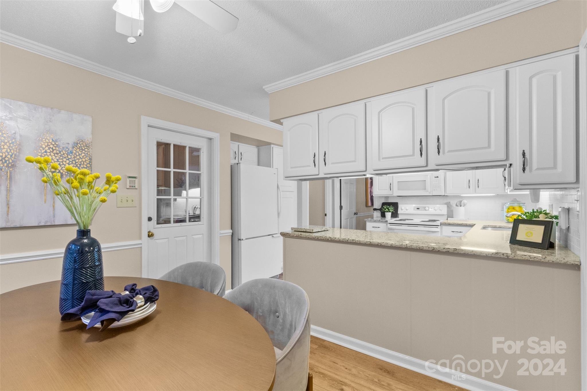 348 Beverly Circle Charlotte, NC 28270 - Photo 10 of 45 a kitchen with stainless steel appliances granite countertop a sink dishwasher and cabinets with wooden floor