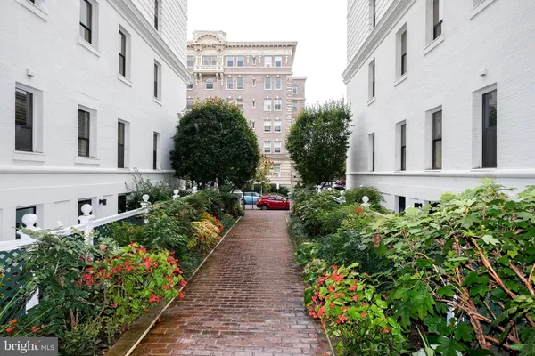 a view of a multi story building with flower pots