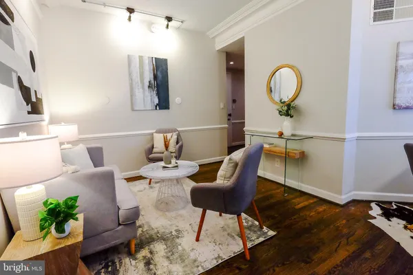 a view of a dining room with furniture and a potted plant