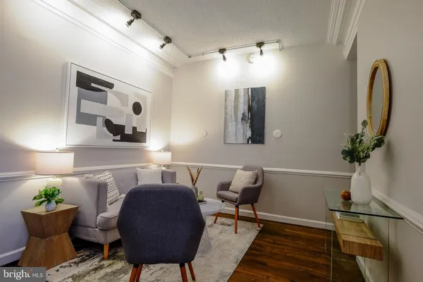 a view of a dining room with furniture and a potted plant
