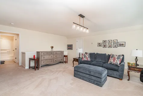a living room with furniture and a ceiling fan