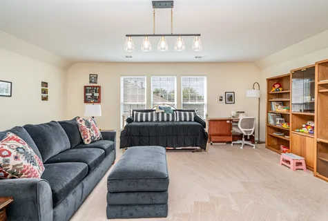 a bedroom with furniture and a large window