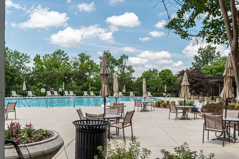 a view of a patio with couches table and chairs and potted plants