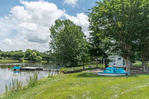 a view of swimming pool with lawn chairs and couches