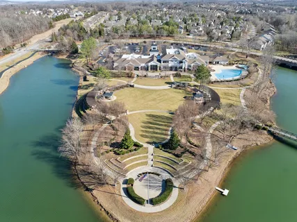 a view of swimming pool with lawn chairs and couches