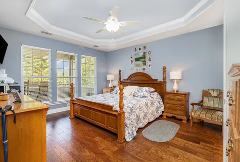 a bedroom with furniture and a large window