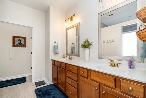 a bathroom with a double vanity sink and a mirror