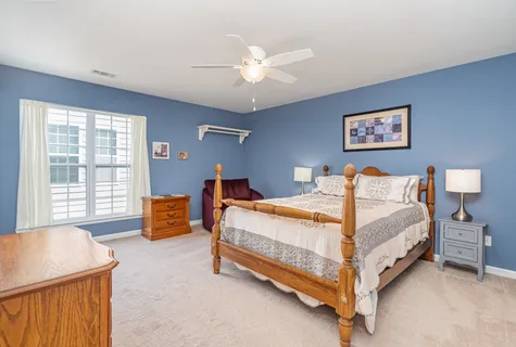 a bed room with a bed and a chandelier