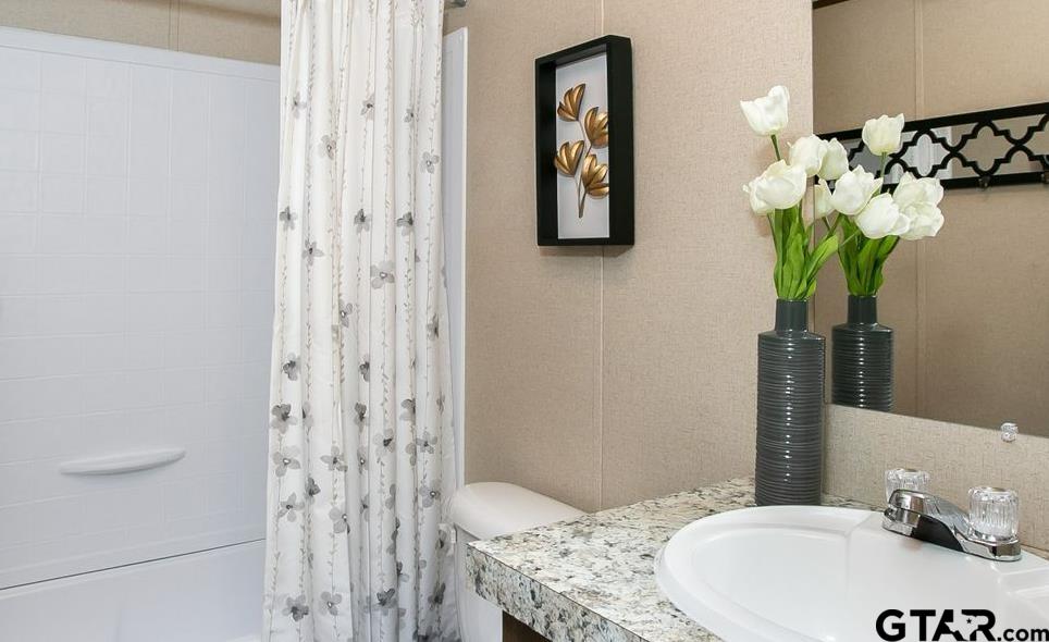 357 Oilfield Road Texarkana, TX 75501 - Photo 16 of 20 a bath room with a sink and a mirror
