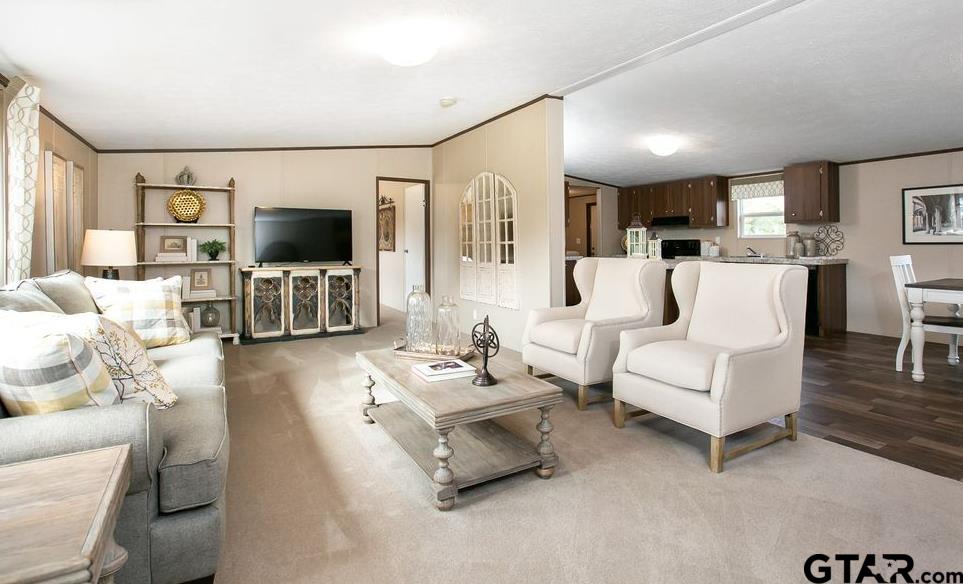 357 Oilfield Road Texarkana, TX 75501 - Photo 4 of 20 a living room with furniture a flat screen tv and a large window