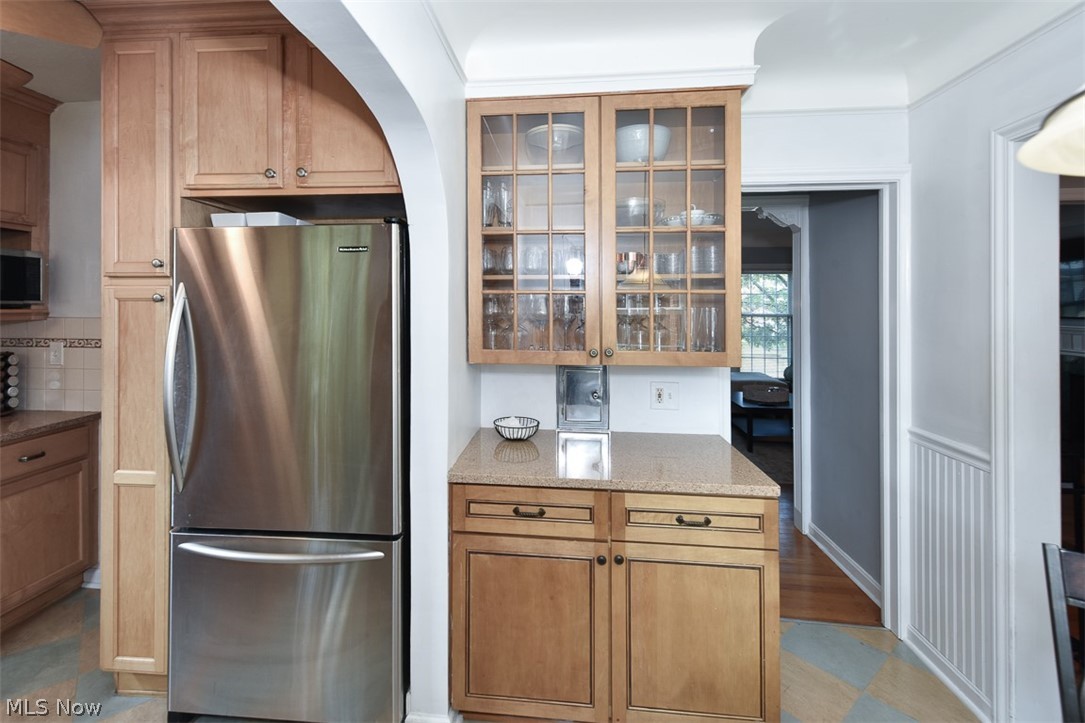 2559 Channing Road Cleveland, OH 44118 - Photo 9 of 28 Kitchen with crown molding, light hardwood / wood-style flooring, backsplash, stainless steel appliances, and light stone countertops