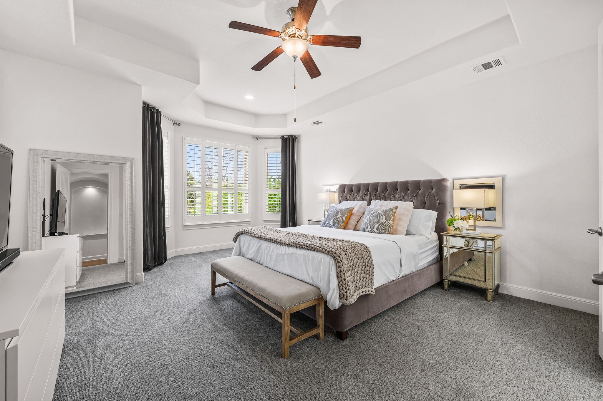 4609 Gallego Circle Austin, TX 78738 - Photo 10 of 40 Primary Bedroom with a raised ceiling, ceiling fan, and carpet floors