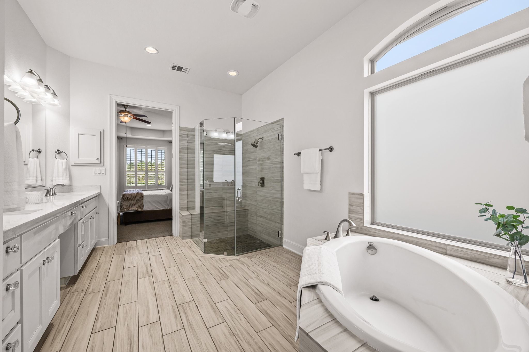 4609 Gallego Circle Austin, TX 78738 - Photo 13 of 40 Full bathroom with a garden tub, double vanity, connected bathroom, a stall shower, and ceiling fan