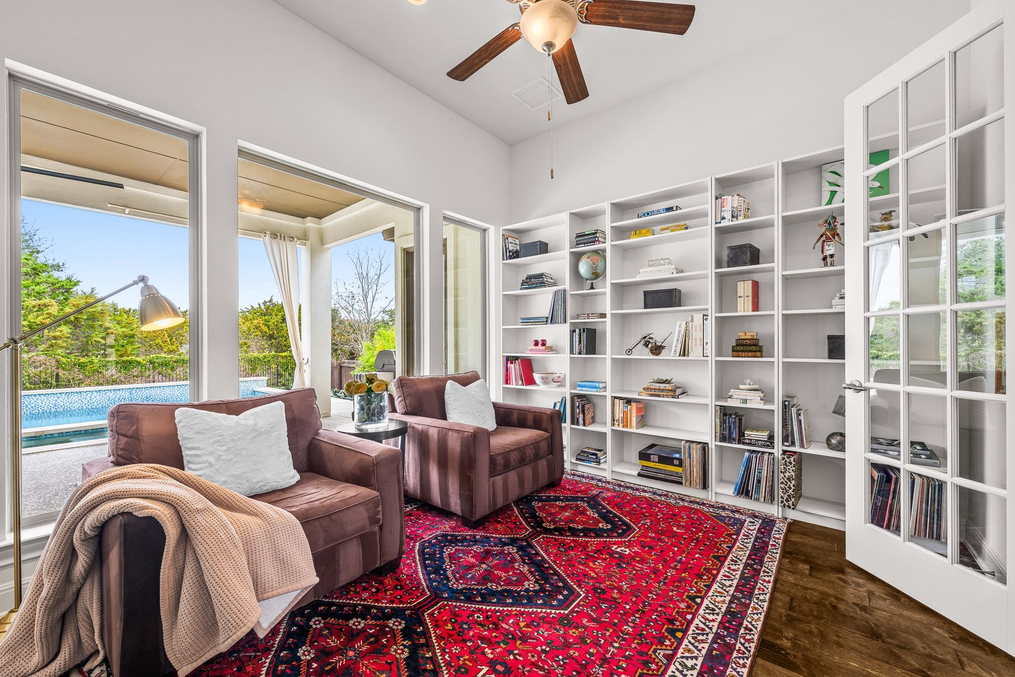 4609 Gallego Circle Austin, TX 78738 - Photo 14 of 40 The living/library area features beautiful windows that allow plenty of natural light to fill the space. It is designed with dark wood-style flooring.