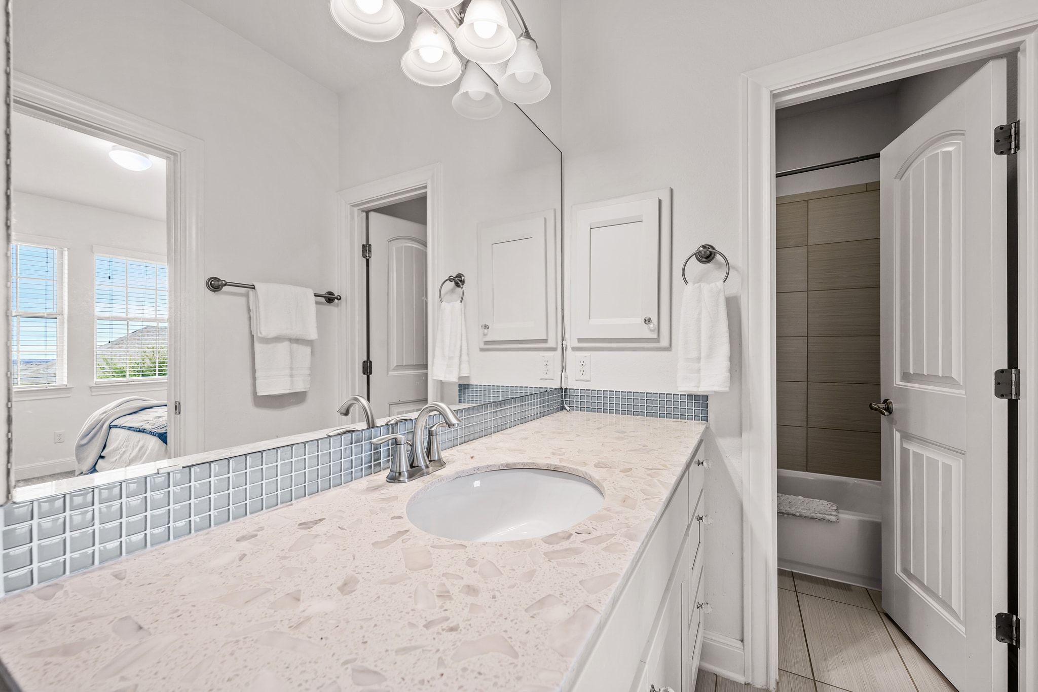 4609 Gallego Circle Austin, TX 78738 - Photo 26 of 40 Full ensuite bathroom featuring vanity, a chandelier, shower / bath combo with shower curtain, and light tile patterned flooring