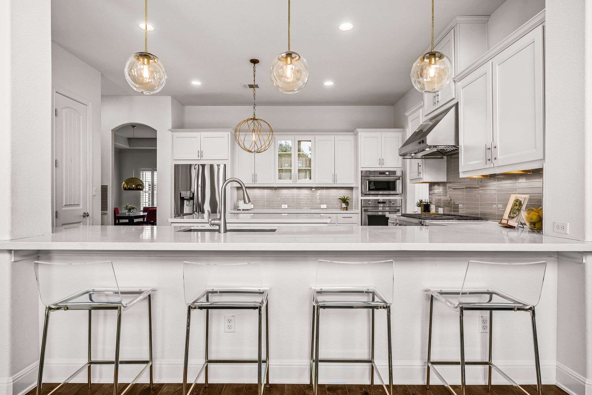 4609 Gallego Circle Austin, TX 78738 - Photo 7 of 40 Kitchen featuring a peninsula, a breakfast bar, white cabinetry, light stone counters, and recessed lighting