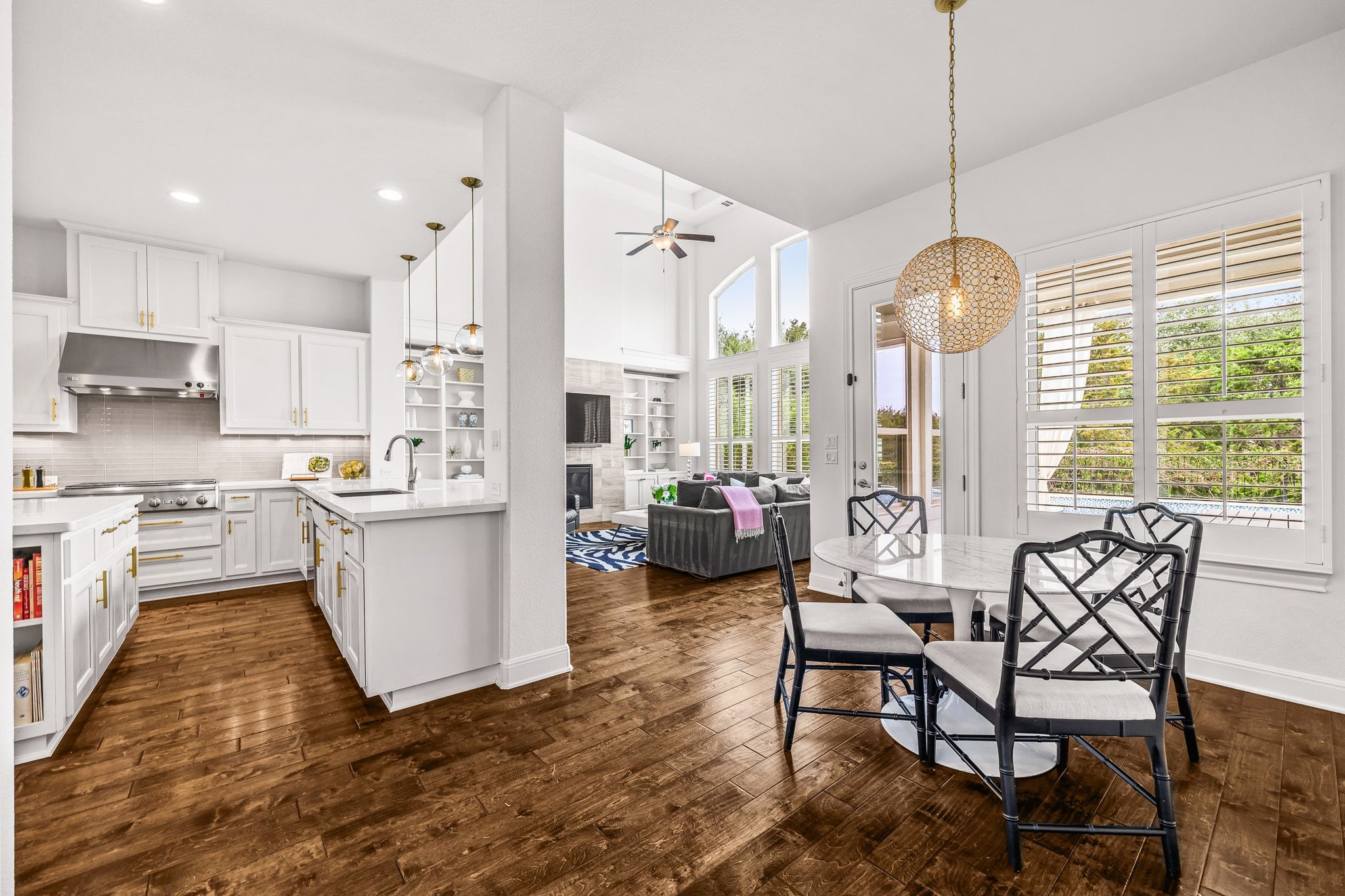 4609 Gallego Circle Austin, TX 78738 - Photo 40 of 40 Kitchen with pendant lighting, white cabinetry, open floor plan, a fireplace, and recessed lighting