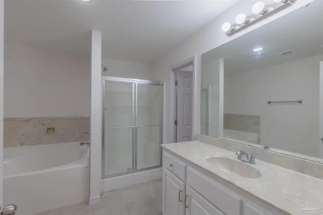 a bathroom with a granite countertop toilet and a shower