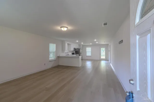 a view of a kitchen with a sink cabinets and wooden floor