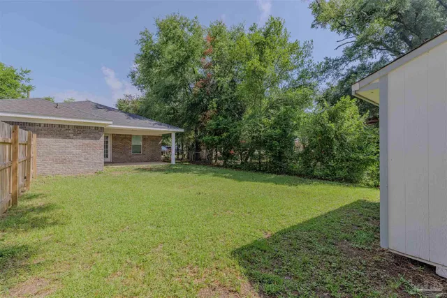 a view of a house with a backyard