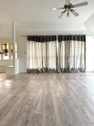 a kitchen with a refrigerator sink and wooden floor