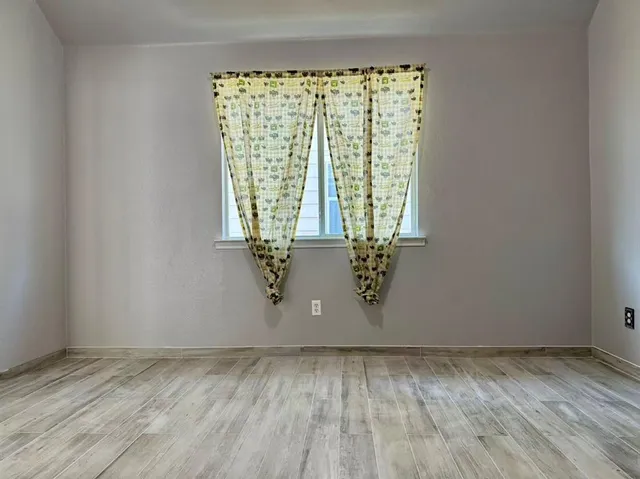 a bath tub sitting in a bathroom next to a window
