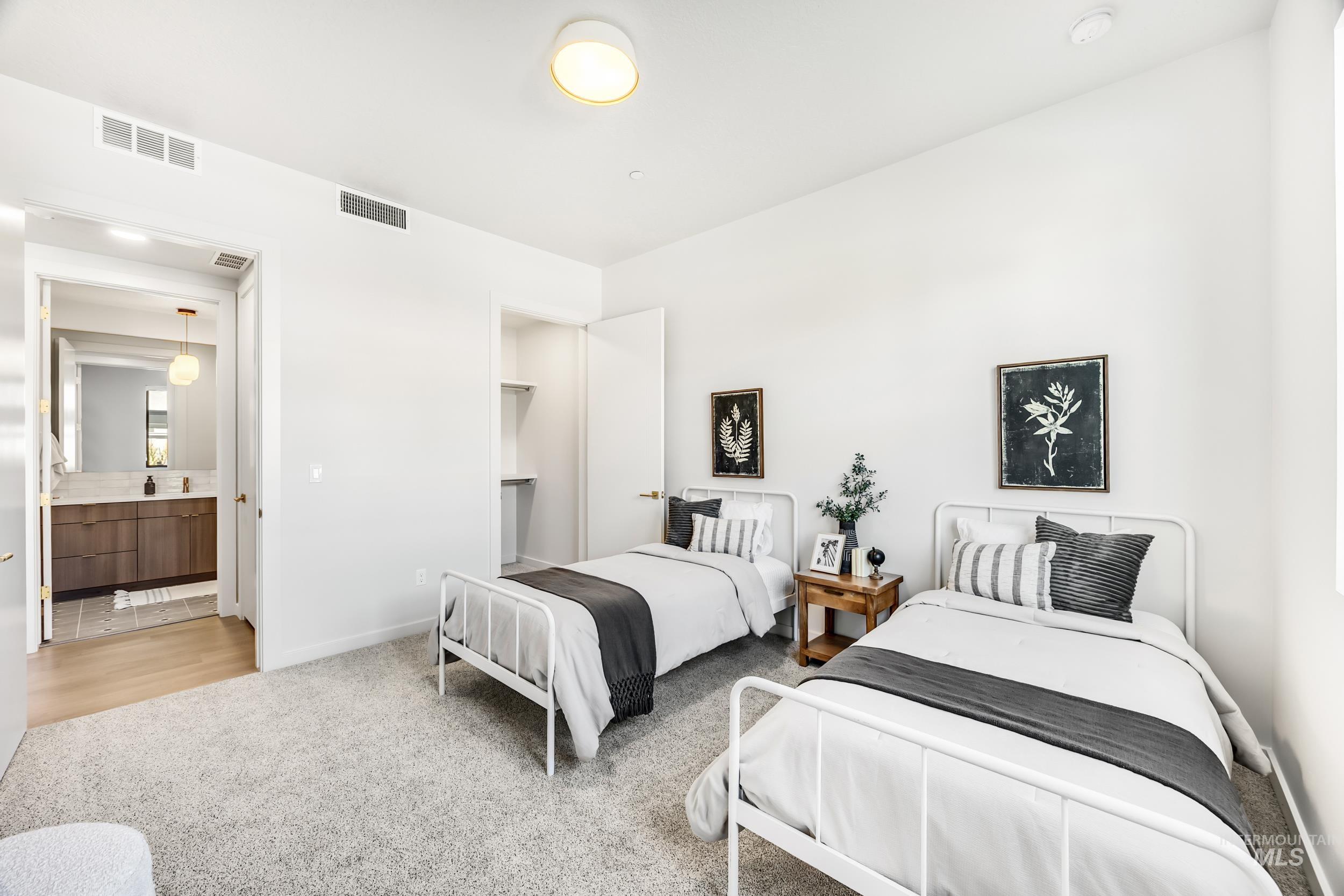 4340 East Haystack Street, Unit 104 Boise, ID 83716 - Photo 20 of 50 Bedroom with light colored carpet and ensuite bath