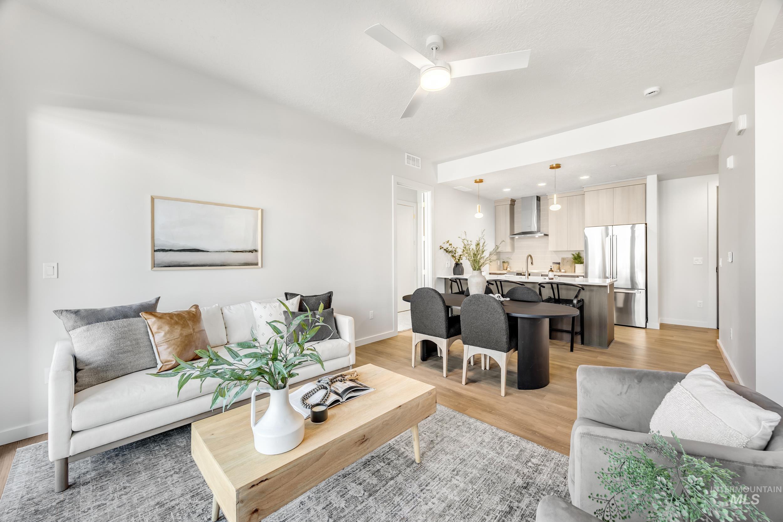 4340 East Haystack Street, Unit 104 Boise, ID 83716 - Photo 6 of 50 Living room with light wood finished floors and ceiling fan