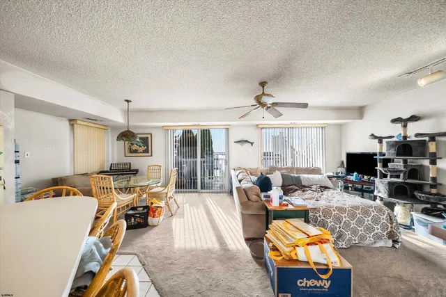 a living room with furniture a flat screen tv and a large window