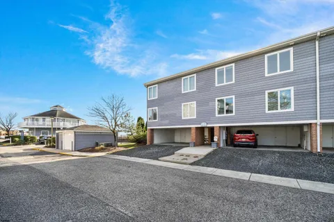 a front view of a house with a road