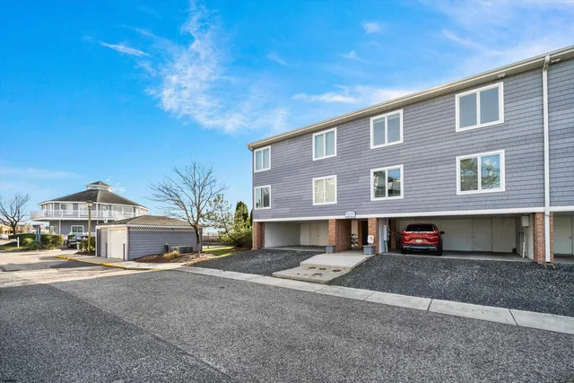 a front view of a house with a road