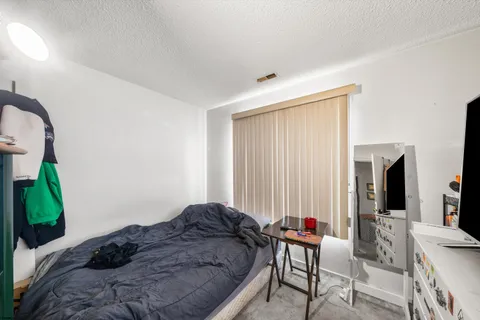 a bedroom with furniture and a large window