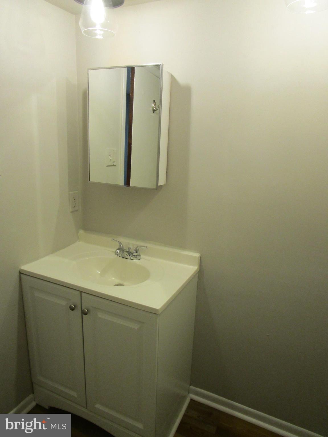 233 Township Line Road, Unit 2A Elkins Park, PA 19027 - Photo 12 of 24 a bathroom with a sink and mirror