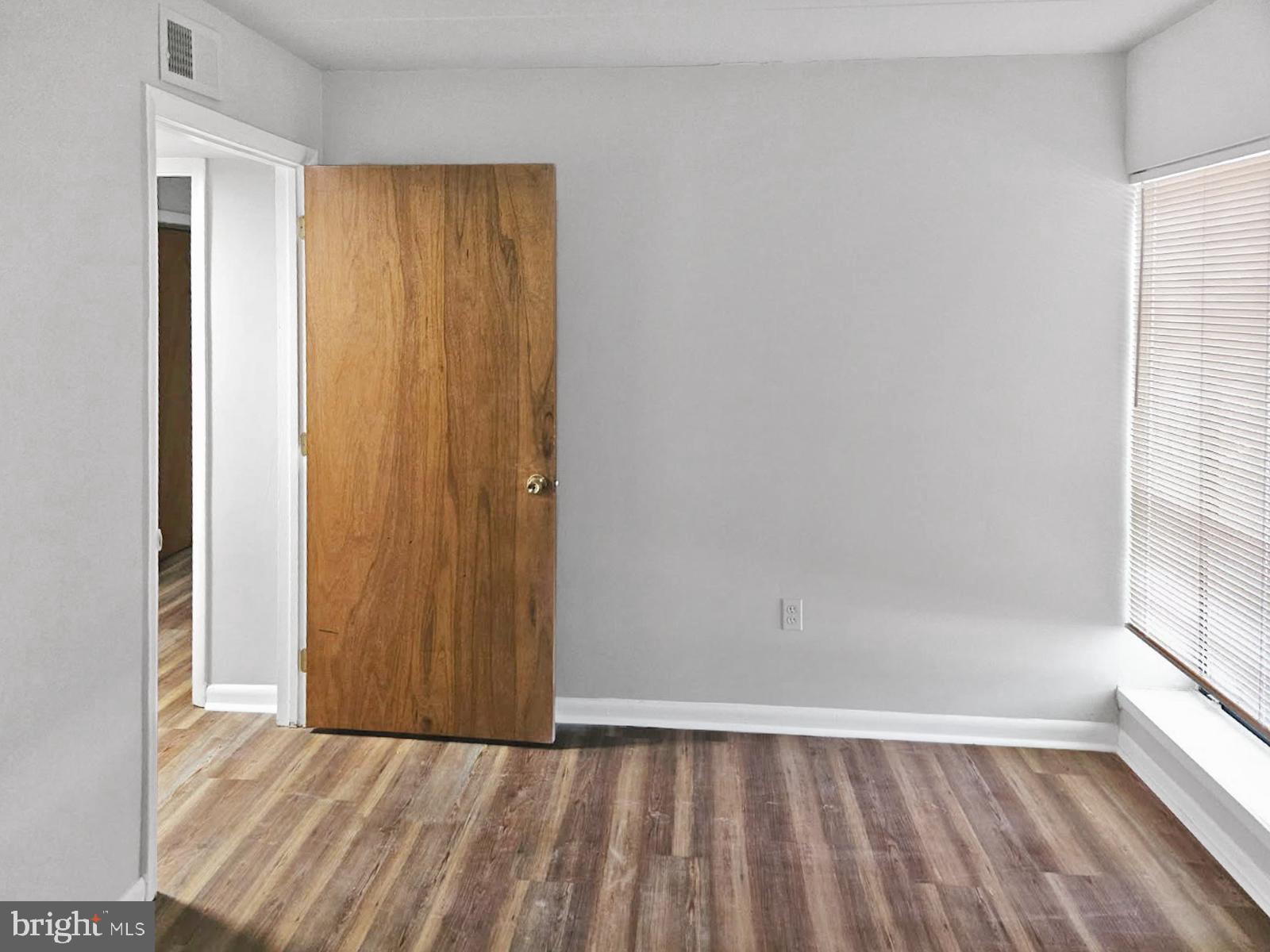 233 Township Line Road, Unit 2A Elkins Park, PA 19027 - Photo 20 of 24 an empty room with wooden floor and windows
