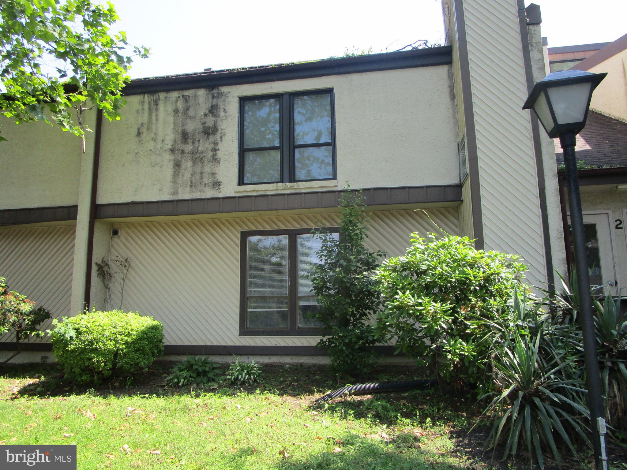 233 Township Line Road, Unit 2A Elkins Park, PA 19027 - Photo 21 of 24 a front view of a house with garden
