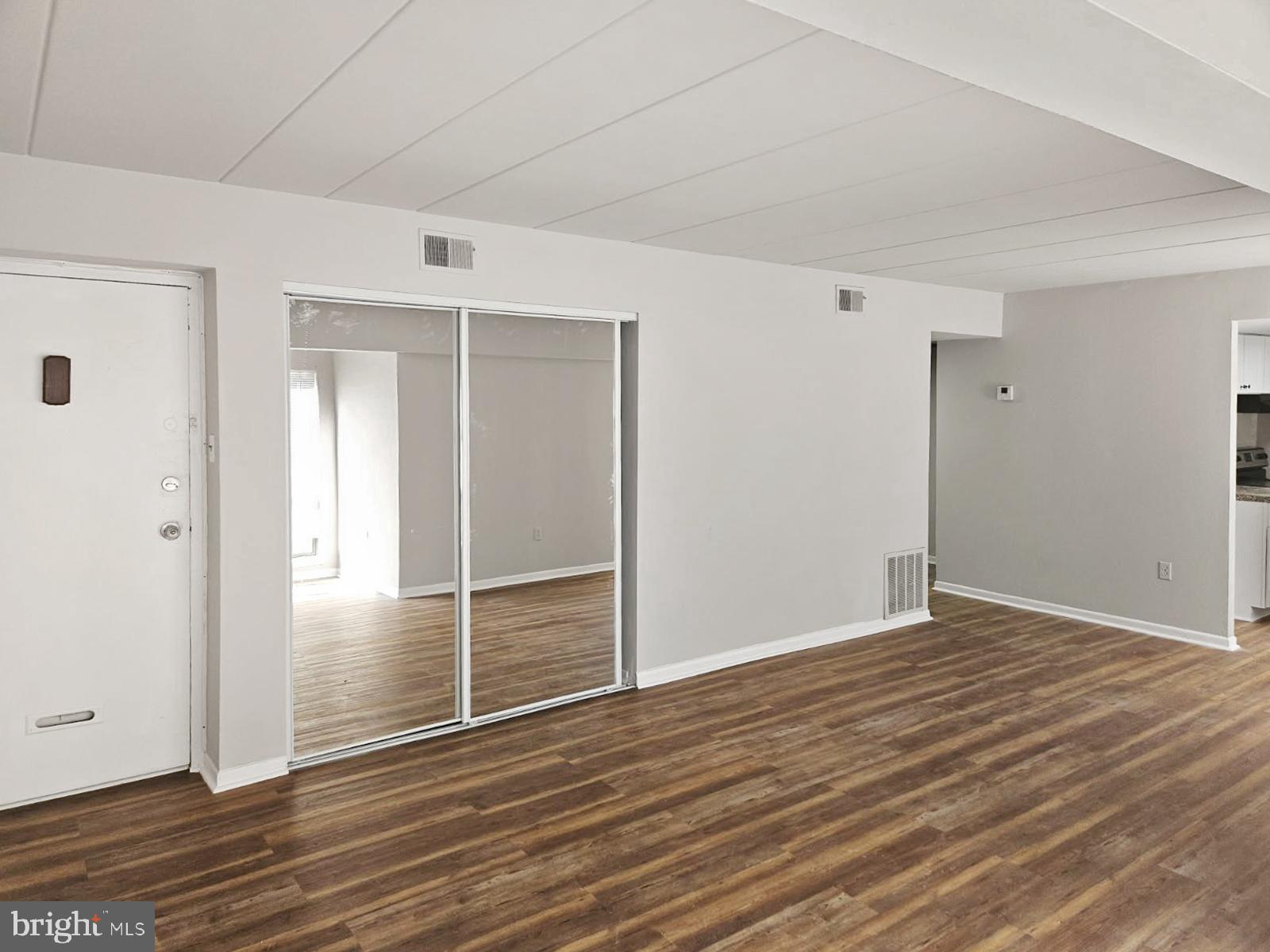 233 Township Line Road, Unit 2A Elkins Park, PA 19027 - Photo 3 of 24 an empty room with wooden floor & windows