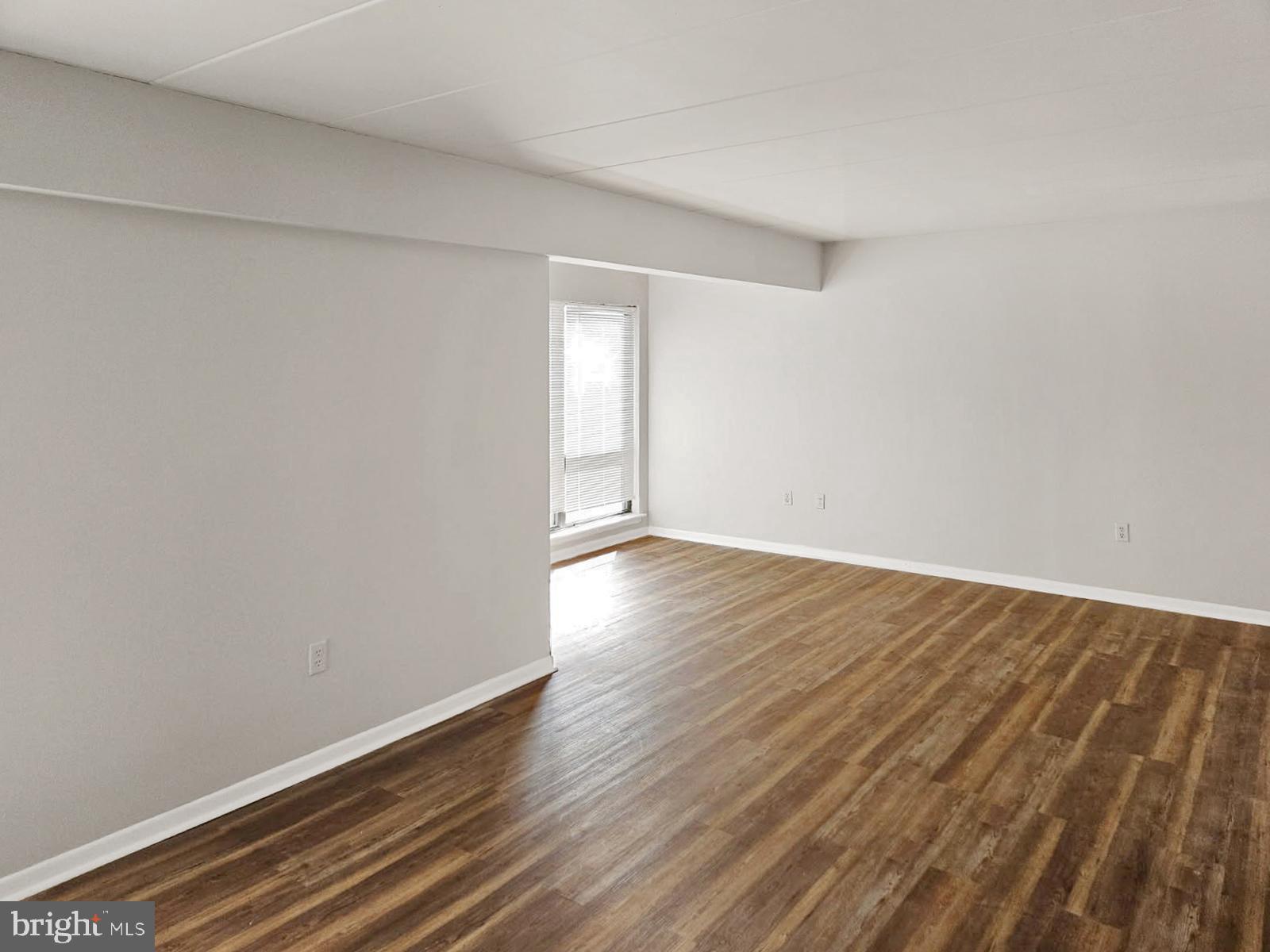 233 Township Line Road, Unit 2A Elkins Park, PA 19027 - Photo 4 of 24 a view of an empty room with wooden floor